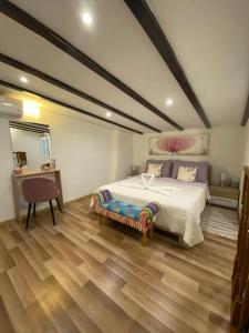 a bedroom with a bed and a table and a chair at Apartman u srcu antičke Pule in Pula