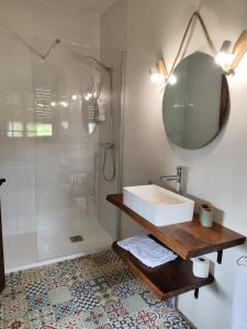 a bathroom with a sink and a shower at Pension Castio in Santillana del Mar