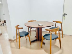 a wooden table and chairs and a table and chairs at The Colombo Home in Nugegoda