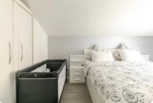 a bedroom with a bed and a dresser next to it at Maisonnette avec terrasse in Strasbourg