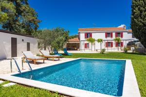 a swimming pool in the backyard of a house at Casa Mirna for 7 people near Pula with sea view & only 2 km from the sea in Peruški