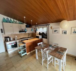 a kitchen and dining room with a table and chairs at Holiday House Mia in Ražanj