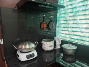 a kitchen with a stove with a pot on it at Affordable Family Loft near SM Uptown Cagayan de Oro in Cagayan de Oro +19 photos
