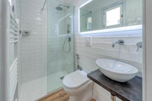 a bathroom with a toilet and a sink and a shower at San Biagio Apartment Lecce in Lecce +12 photos