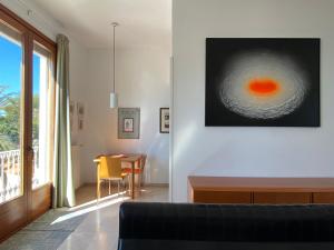 a living room with a couch and a table at Exclusive Beachfront Haven in Costa Brava in Lloret de Mar