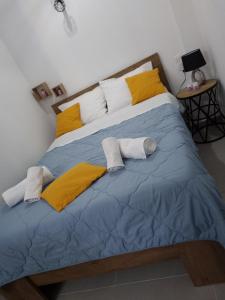 duże łóżko z żółtymi i białymi poduszkami w obiekcie Kapsala's family HOME w mieście Agios Ioannis Pelio
