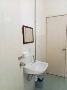 a white bathroom with a sink and a mirror at Taman Sunway Tunas in Bayan Lepas +17 photos