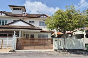 a house with a wooden fence in front of it at Taman Sunway Tunas in Bayan Lepas