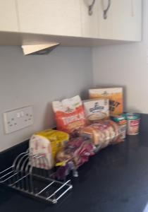 a counter top with a bunch of food on it at Mac’s- Double Room shared bathroom in Belfast +3 photos