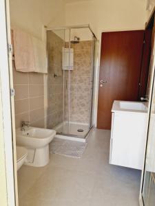 a bathroom with a shower and a toilet and a sink at Affittacamere Sofy in Villasimius