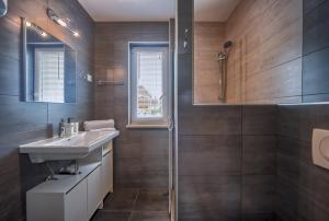 a bathroom with a sink and a shower at Apartments LAURA in Fažana +59 photos
