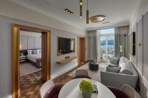 a living room with a couch and a room with a bed at Mandarin Oriental Palace, Luzern in Lucerne