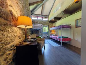 a room with a desk and a room with bunk beds at Quinta Estrada Romana - Albergue de Peregrinos in Cerdal