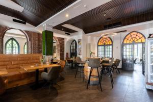 a restaurant with tables and chairs and windows at Wirtshaus & Hotel Landsknecht in Meerbusch