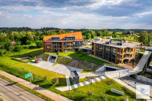 an aerial view of a building with a park at Lake Rental Pratum 32 in Mikołajki