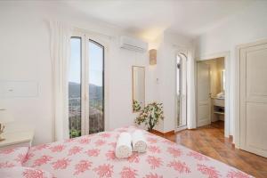 a bedroom with a bed with two white towels on it at Villa Corallia - Luxury Villa with sea view in Torre delle Stelle +24 photos