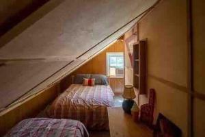 a bedroom with two beds in a attic at Memory Island in Hammondsport