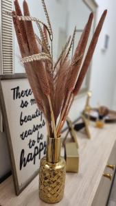 a vase filled with feathers sitting on a counter at La Gubbiata in Bologna