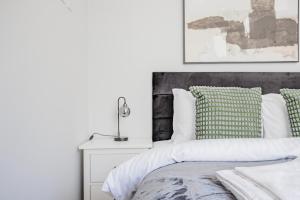 a bedroom with a bed and a lamp on a night stand at Host & Stay - Bridge Street Apartments in Evesham