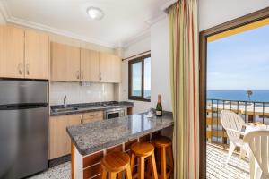 a kitchen with a view of the ocean at Los Ficus in Playa del Ingles