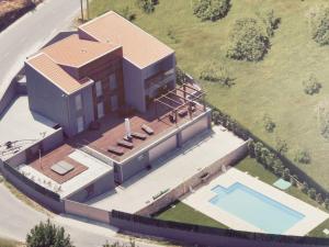 an overhead view of a house with a swimming pool at Casa da Recosta Douro Country House in Resende