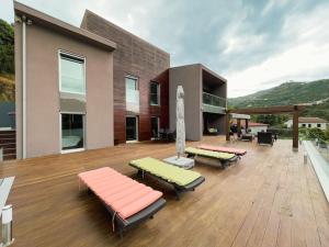 a house with chaise lounges on a wooden deck at Casa da Recosta Douro Country House in Resende