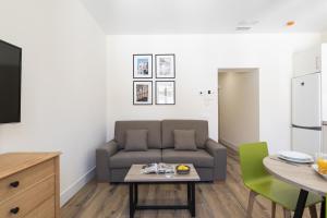 a living room with a couch and a table at Apartamentos Blume Conde Aranda in Madrid