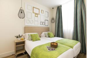 a bedroom with two beds and a basket on top of it at Apartamentos Blume Conde Aranda in Madrid