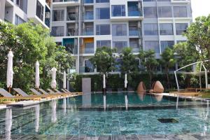 a swimming pool in front of a building at Lakeside Residences by NLA in Bang Tao Beach