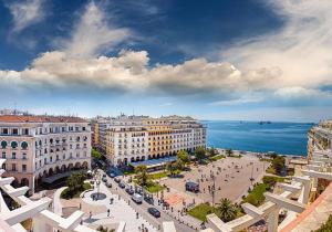 a view of a city with buildings and the ocean at Happiness studio with terrace. in Thessaloniki