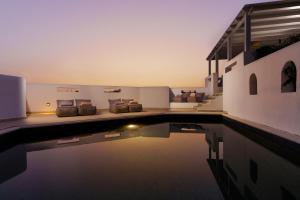 a house with a swimming pool next to a building at Sunrise Paros by Mr and Mrs White in Naousa