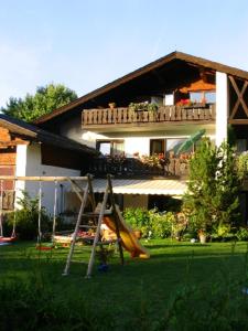 ein Haus mit einem Spielplatz davor in der Unterkunft Alpen - Apartments in Garmisch-Partenkirchen