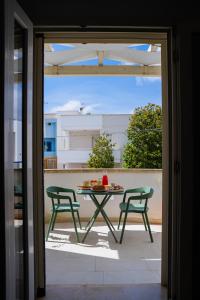 a table and two chairs on a balcony at La Casa al mare Torre San Giovanni in Torre San Giovanni Ugento +29 photos