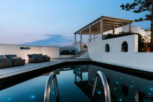 a villa with a swimming pool at night at Sunrise Paros in Naousa