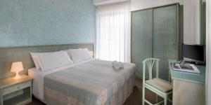 Postel nebo postele na pokoji v ubytování Hotel Cristina Corona