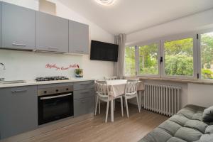 a kitchen and dining room with a table and a couch at Residenza Nonno Mella in Porto SantʼElpidio