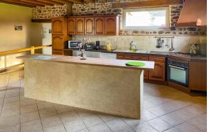 a kitchen with a large island in the middle at Lake Front Home In Moitron-Sur-Sarthe in Moitron-sur-Sarthe