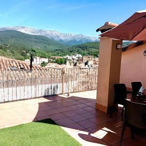 a balcony of a house with a view of mountains at Casa Vaélico in Arenas de San Pedro +23 photos