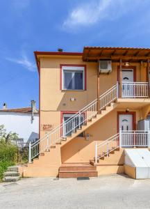 a house with stairs in front of it at AGALI HOUSE in Limenaria