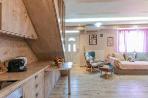 a living room with a couch and a table at AGALI HOUSE in Limenaria