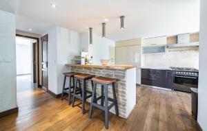 a kitchen with a stone counter and stools in it at House With Pool Panoramic View in Saint-Cézaire-sur-Siagne