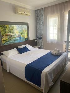 a bedroom with a large bed with a large window at EON DALYAN BOUTIQIE HOTEL in Ortaca