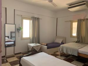 um quarto com 2 camas e uma janela em The Way Hostel 4 persons Room em Dahab