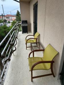 two chairs and a table on a balcony at Nona - 200m from the beach in Jadranovo +11 photos