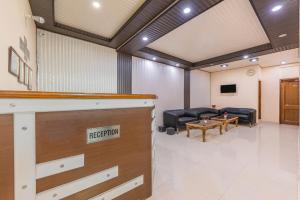 a meeting room with a couch and a table at Hotel Charming Hills By Him Haults Hospitality in Shimla