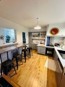 a kitchen with a table and chairs in a kitchen at Belle maison avec jardin expose plein sud proche centre ville in Caen