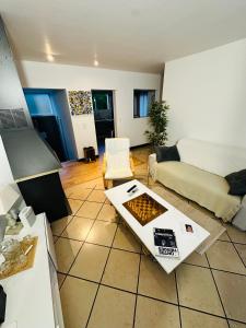 a living room with a couch and a table at Belle maison avec jardin expose plein sud proche centre ville in Caen +8 photos