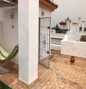 a gate on the side of a building at VILLA MARISMAS DE LA ALMADRABA in Chiclana de la Frontera +8 photos