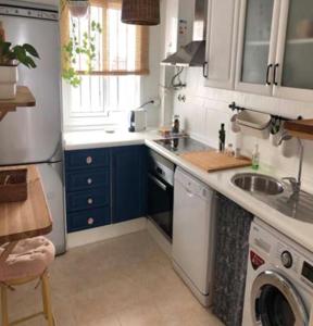 a small kitchen with a sink and a dishwasher at VILLA MARISMAS DE LA ALMADRABA in Chiclana de la Frontera