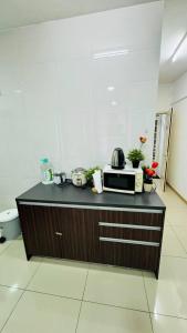 a kitchen with a counter with a microwave on it at Vista Alam Roomstay Homestay in Shah Alam